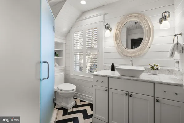 a dining room with furniture water view and a large window