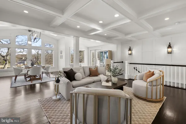 a dining room with wooden floor a chandelier a wooden table and chairs