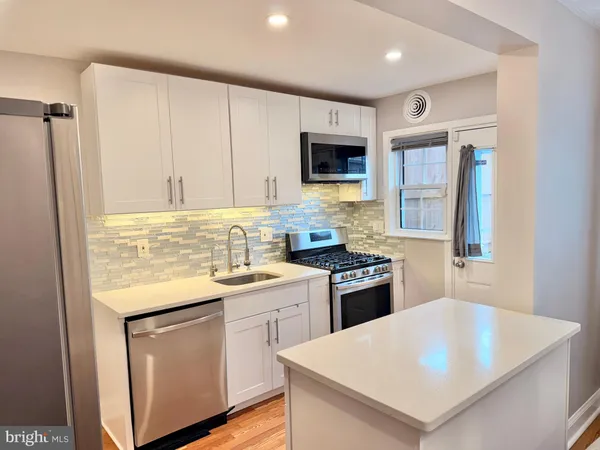 a kitchen with a sink a stove and refrigerator