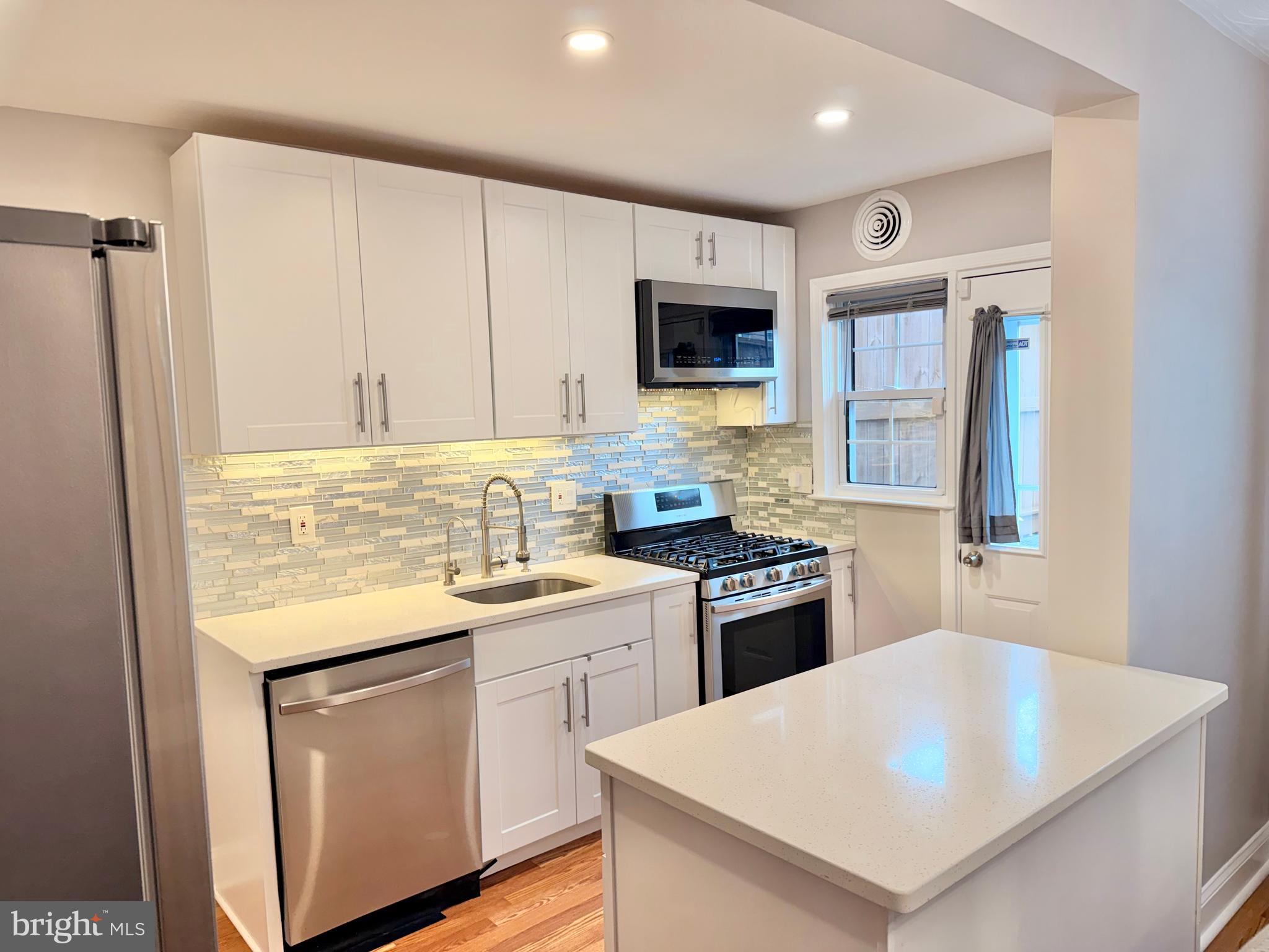 a kitchen with a sink a stove and refrigerator