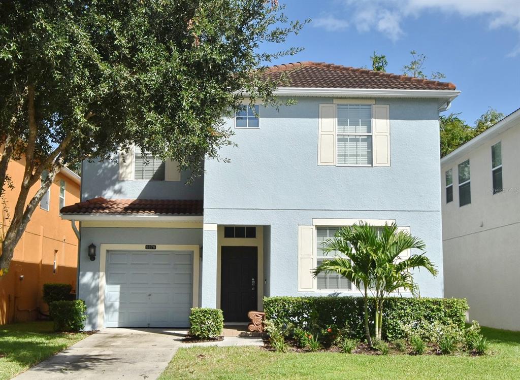 8878 Candy Palm Road Kissimmee, FL 34747 - Photo 1 of 70 a front view of a house with a yard and potted plants