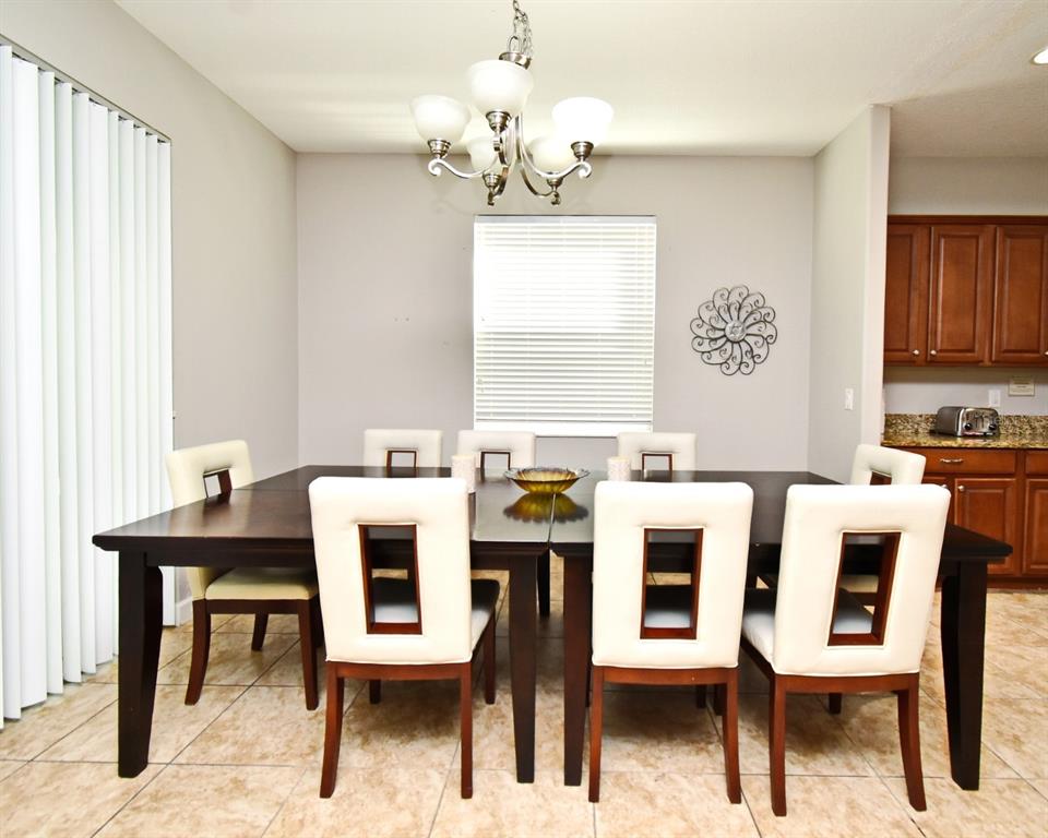 8878 Candy Palm Road Kissimmee, FL 34747 - Photo 12 of 70 a view of a dining room with furniture