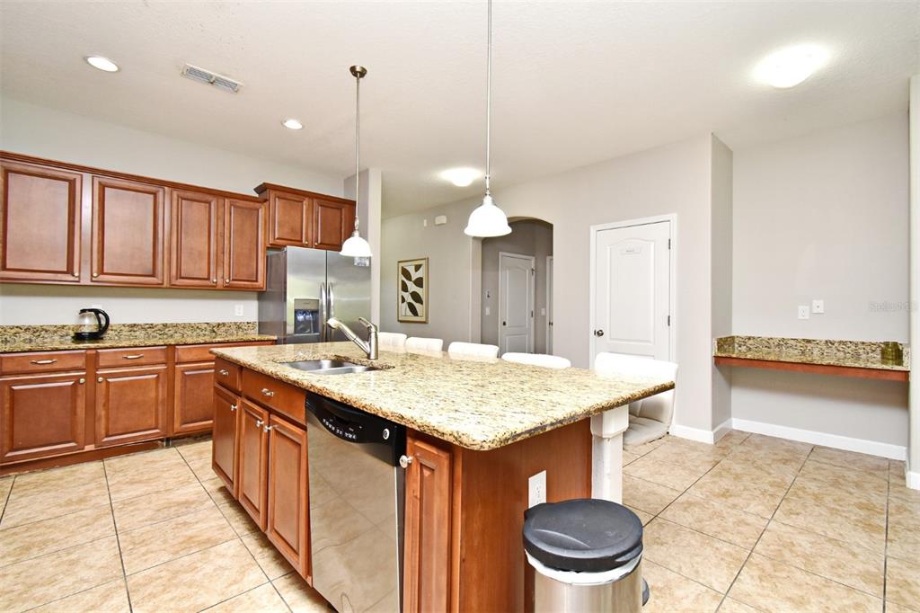 8878 Candy Palm Road Kissimmee, FL 34747 - Photo 13 of 70 a kitchen with a stove sink and cabinets