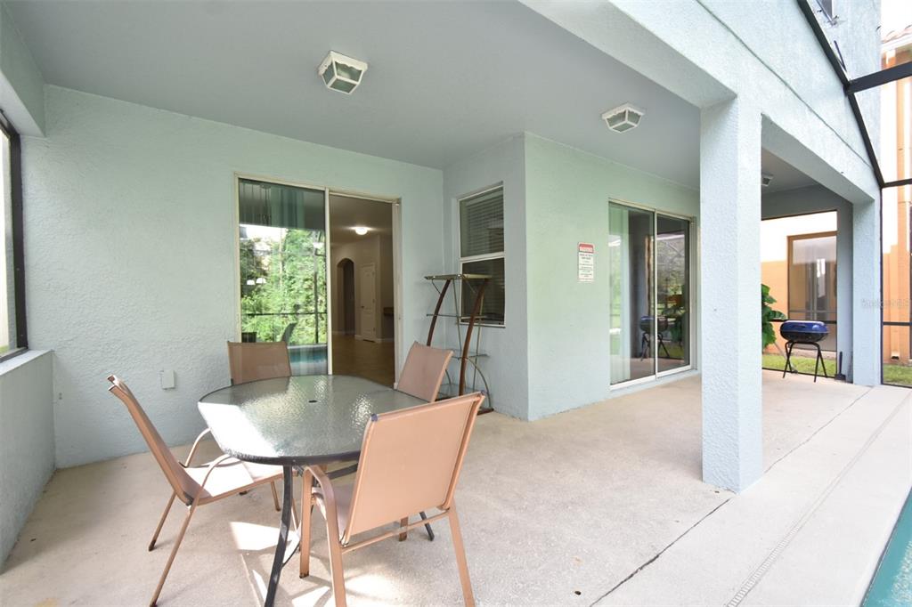 8878 Candy Palm Road Kissimmee, FL 34747 - Photo 23 of 70 a view of a dining room with furniture and a potted plant