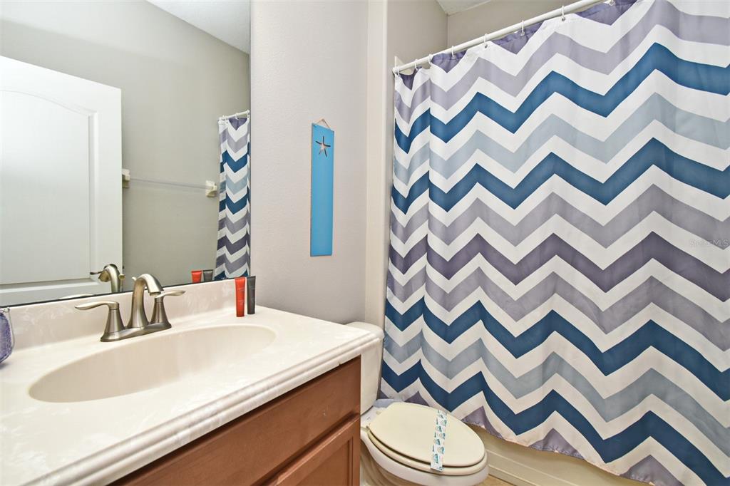 8878 Candy Palm Road Kissimmee, FL 34747 - Photo 27 of 70 a bathroom with a sink and a mirror