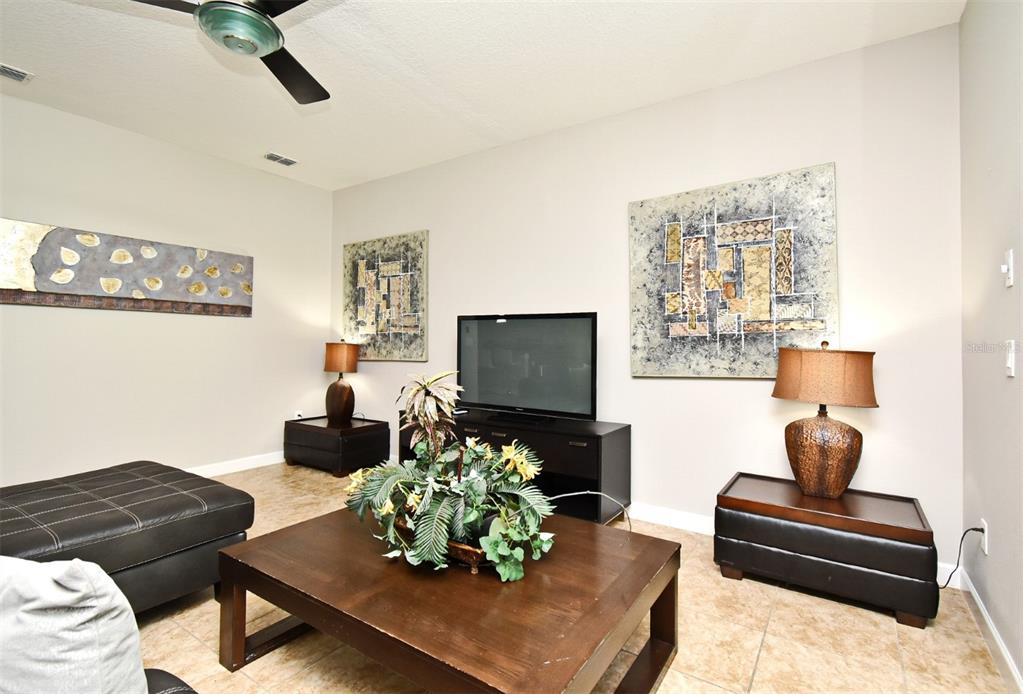 8878 Candy Palm Road Kissimmee, FL 34747 - Photo 3 of 70 a living room with furniture