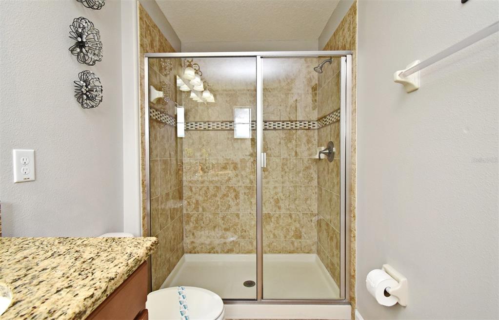 8878 Candy Palm Road Kissimmee, FL 34747 - Photo 31 of 70 a bathroom with a shower sink and toilet