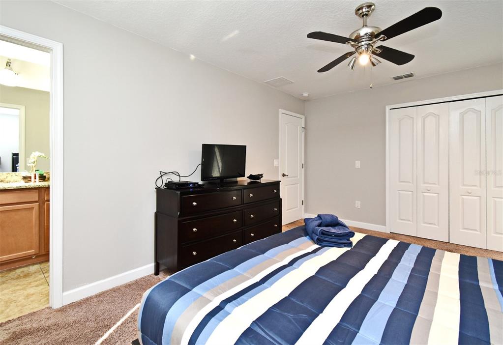 8878 Candy Palm Road Kissimmee, FL 34747 - Photo 33 of 70 a bed room with a bed and a chandelier