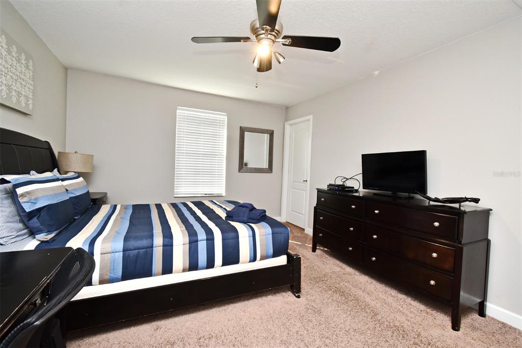 8878 Candy Palm Road Kissimmee, FL 34747 - Photo 35 of 70 a bedroom with a bed and a television
