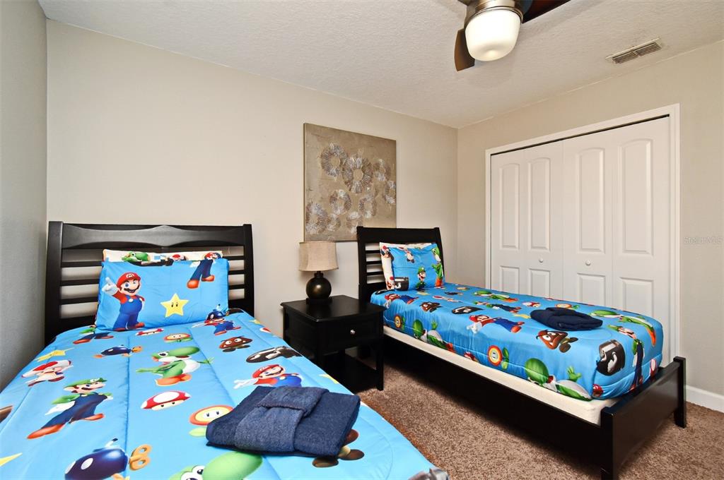 8878 Candy Palm Road Kissimmee, FL 34747 - Photo 40 of 70 a bedroom with a bed and window