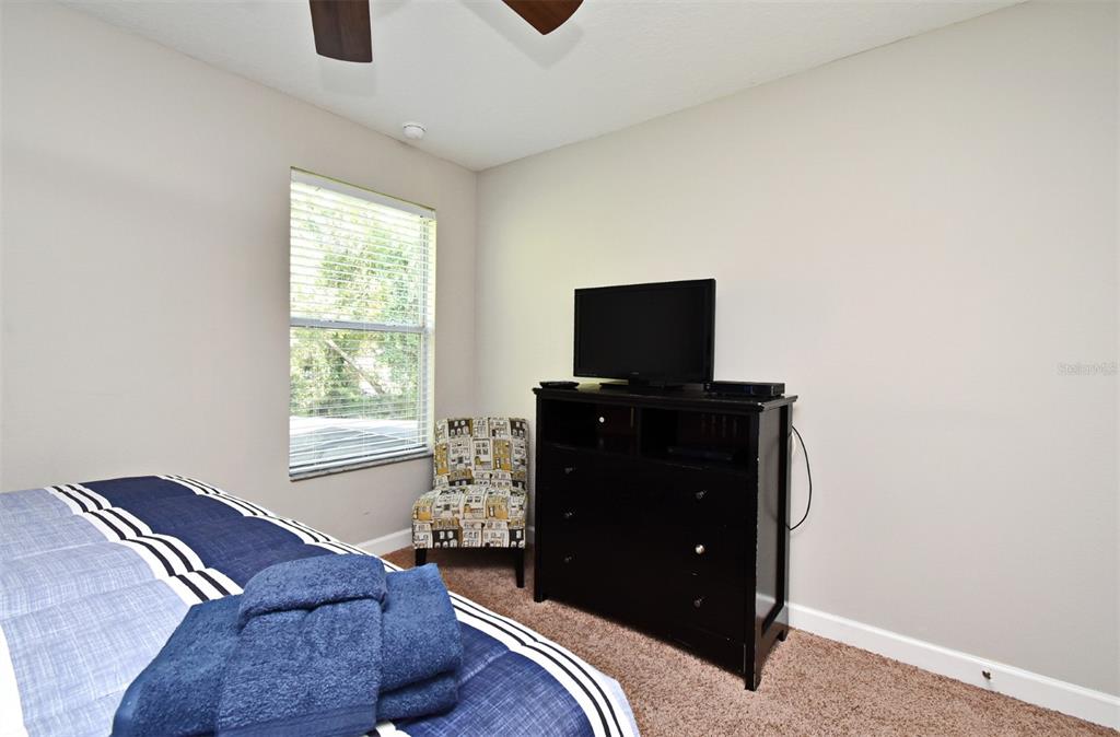 8878 Candy Palm Road Kissimmee, FL 34747 - Photo 44 of 70 a bedroom with a bed and a tv