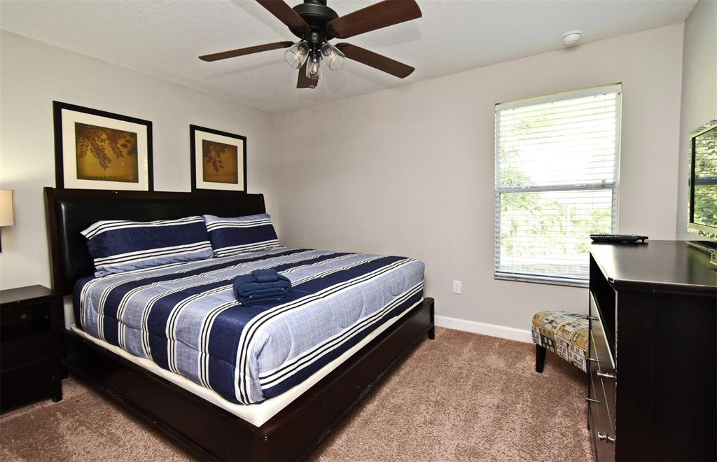 8878 Candy Palm Road Kissimmee, FL 34747 - Photo 45 of 70 a bedroom with a bed and wooden floor