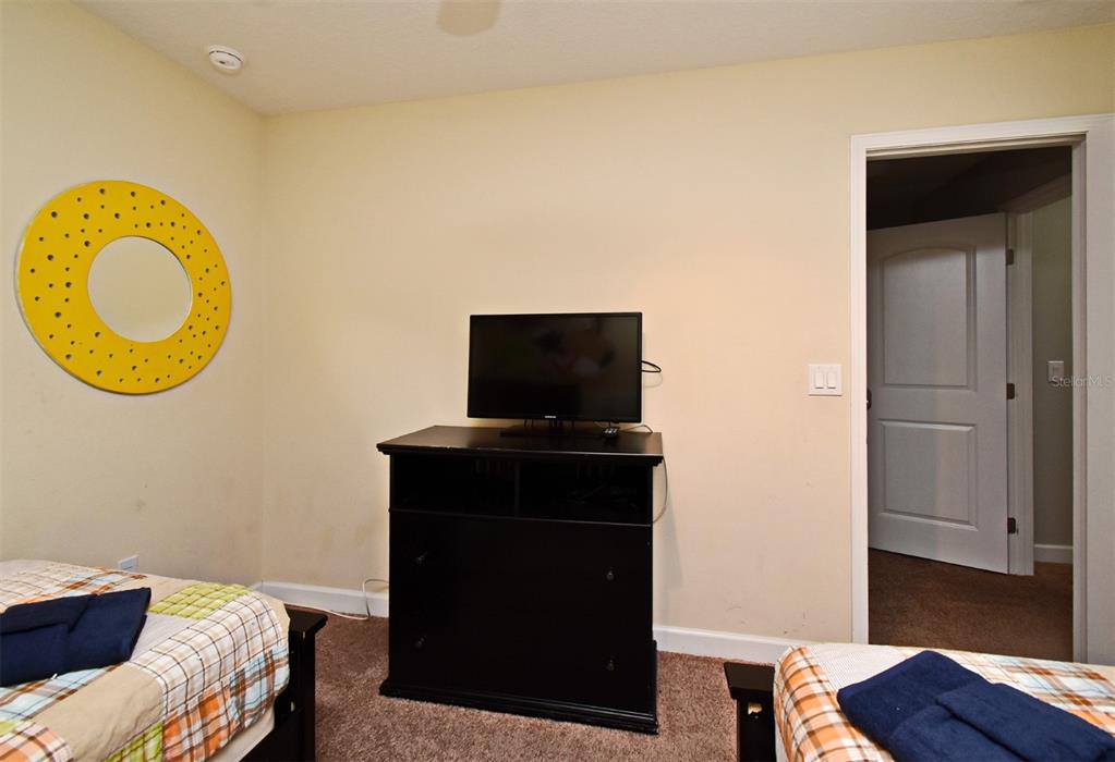 8878 Candy Palm Road Kissimmee, FL 34747 - Photo 46 of 70 a living room with a bed furniture and a window