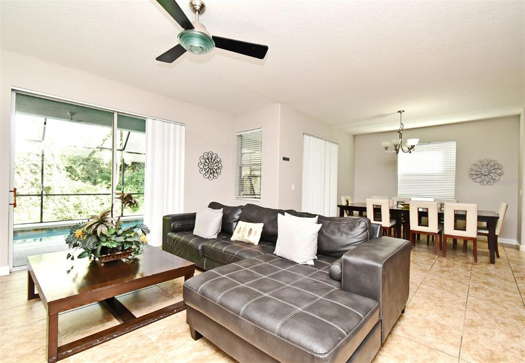 8878 Candy Palm Road Kissimmee, FL 34747 - Photo 5 of 70 a living room with furniture and a large window