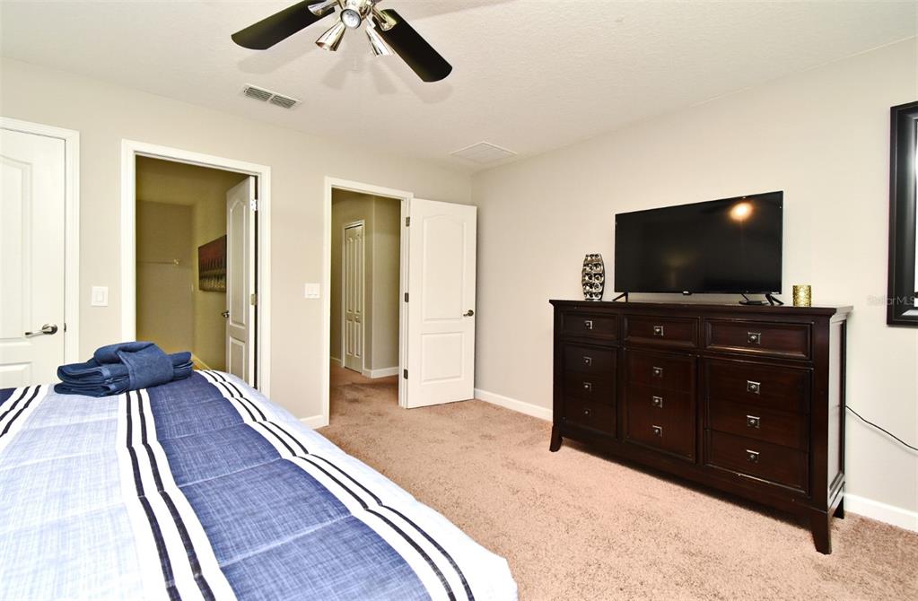 8878 Candy Palm Road Kissimmee, FL 34747 - Photo 52 of 70 a living room with furniture and a flat screen tv