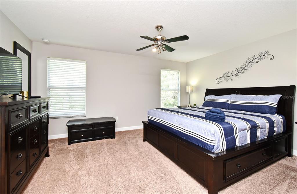8878 Candy Palm Road Kissimmee, FL 34747 - Photo 55 of 70 a bedroom with a bed and a tv