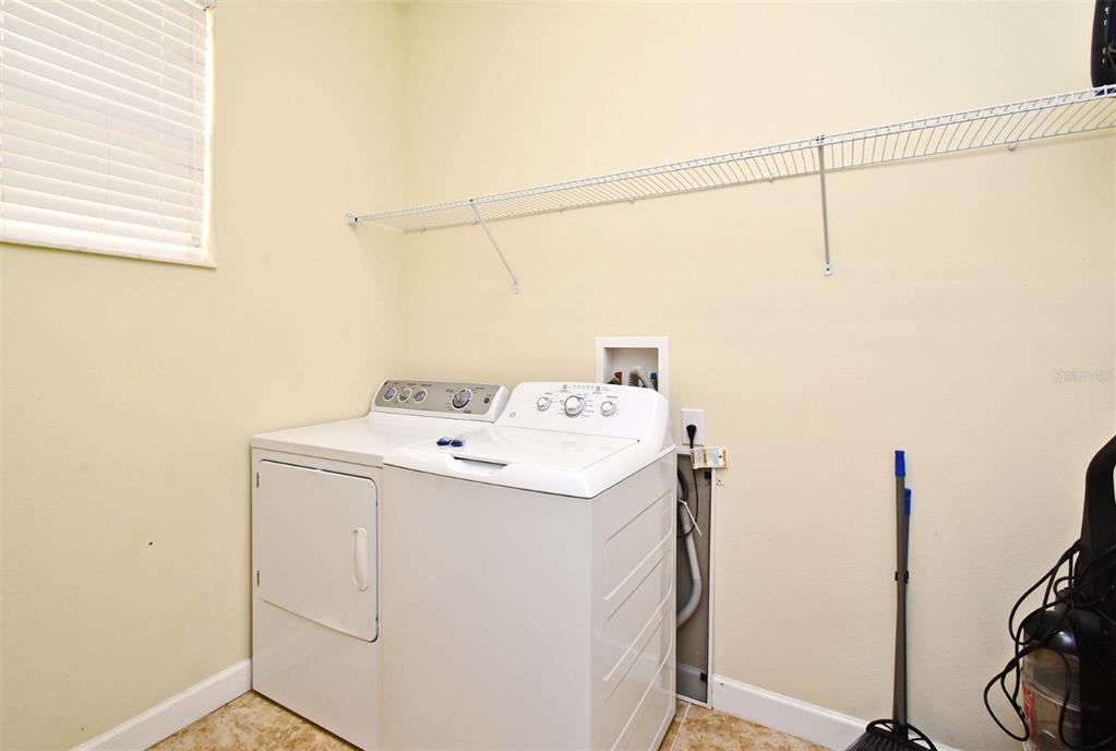 8878 Candy Palm Road Kissimmee, FL 34747 - Photo 56 of 70 a utility room with dryer and washer
