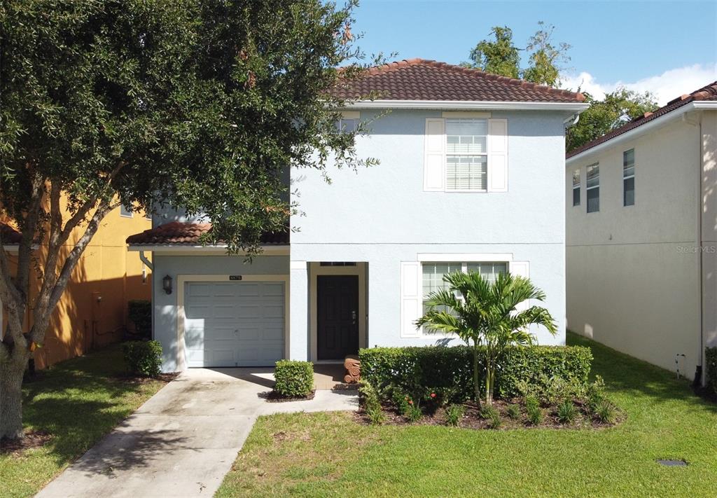 8878 Candy Palm Road Kissimmee, FL 34747 - Photo 57 of 70 a front view of a house with a yard