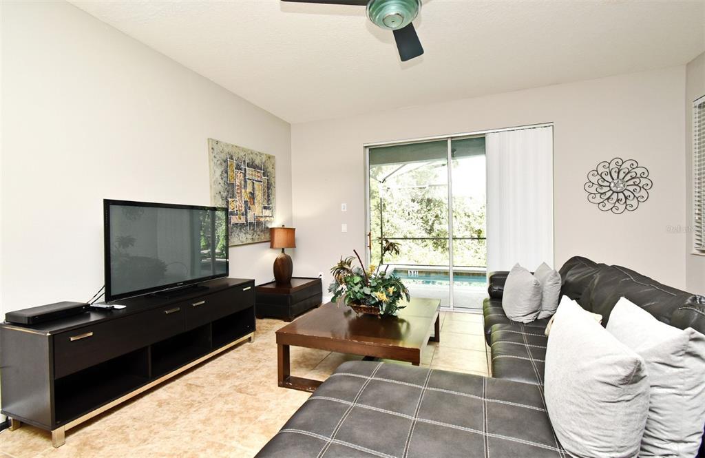 8878 Candy Palm Road Kissimmee, FL 34747 - Photo 6 of 70 a living room with furniture and a flat screen tv