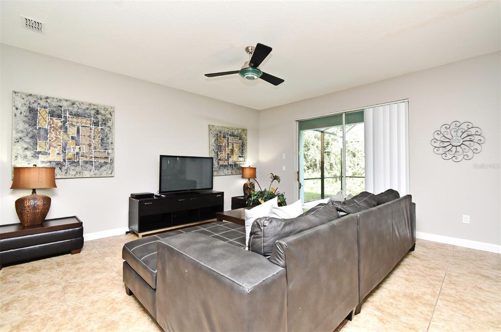 8878 Candy Palm Road Kissimmee, FL 34747 - Photo 7 of 70 a living room with furniture and a flat screen tv