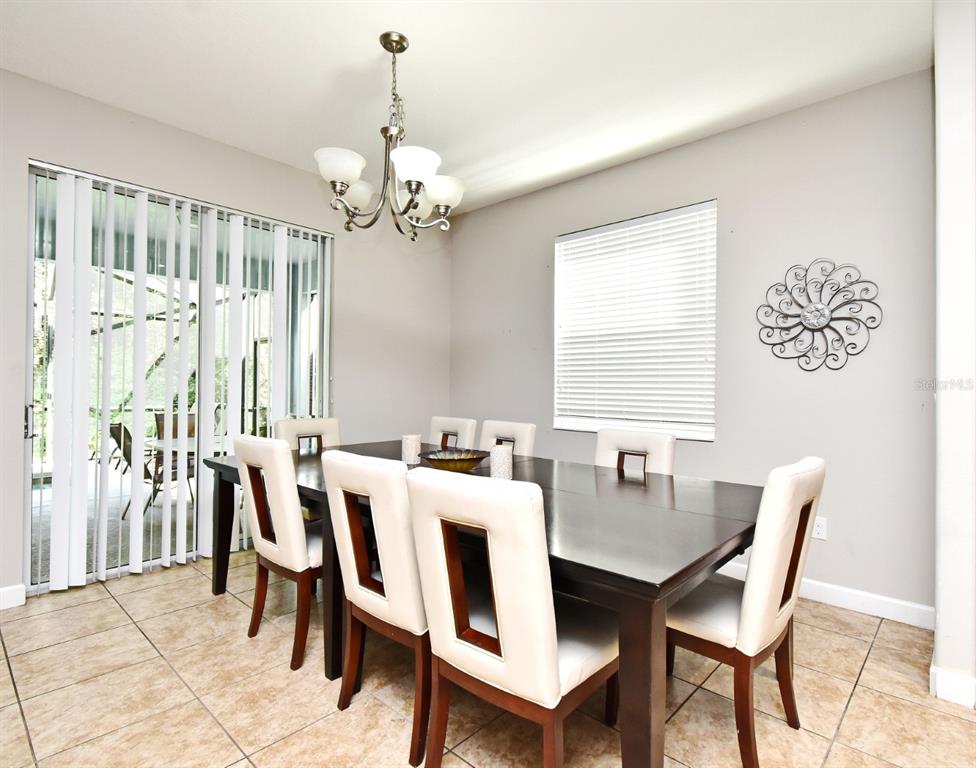 8878 Candy Palm Road Kissimmee, FL 34747 - Photo 8 of 70 a view of a dining room with furniture window and outside view