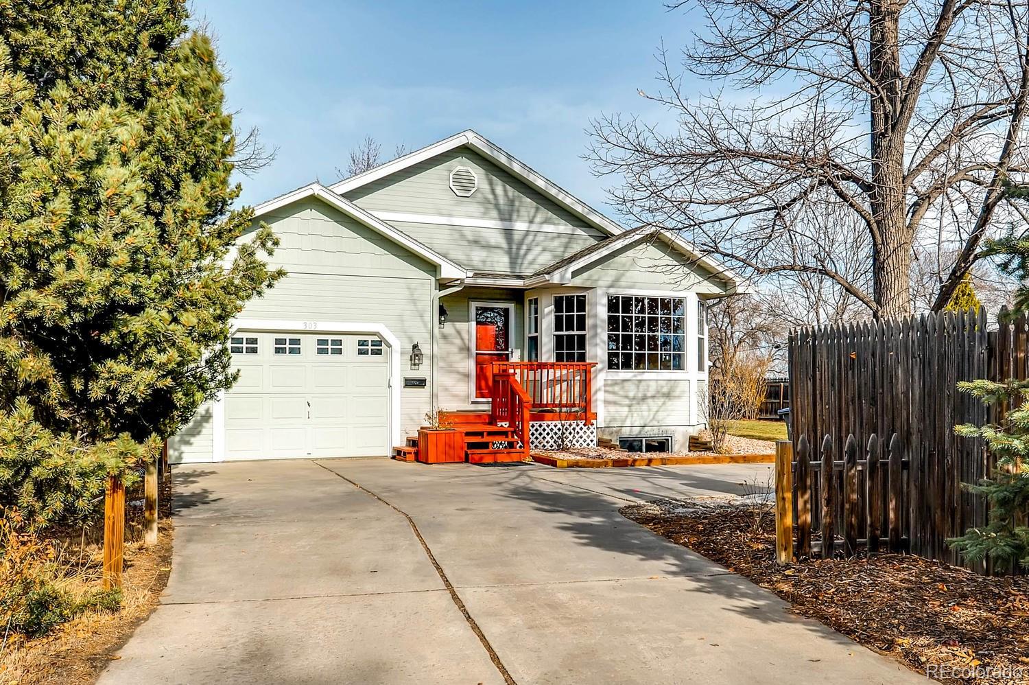 303 West Baseline Road Lafayette, CO 80026 - Photo 1 of 28 a front view of a house with large trees