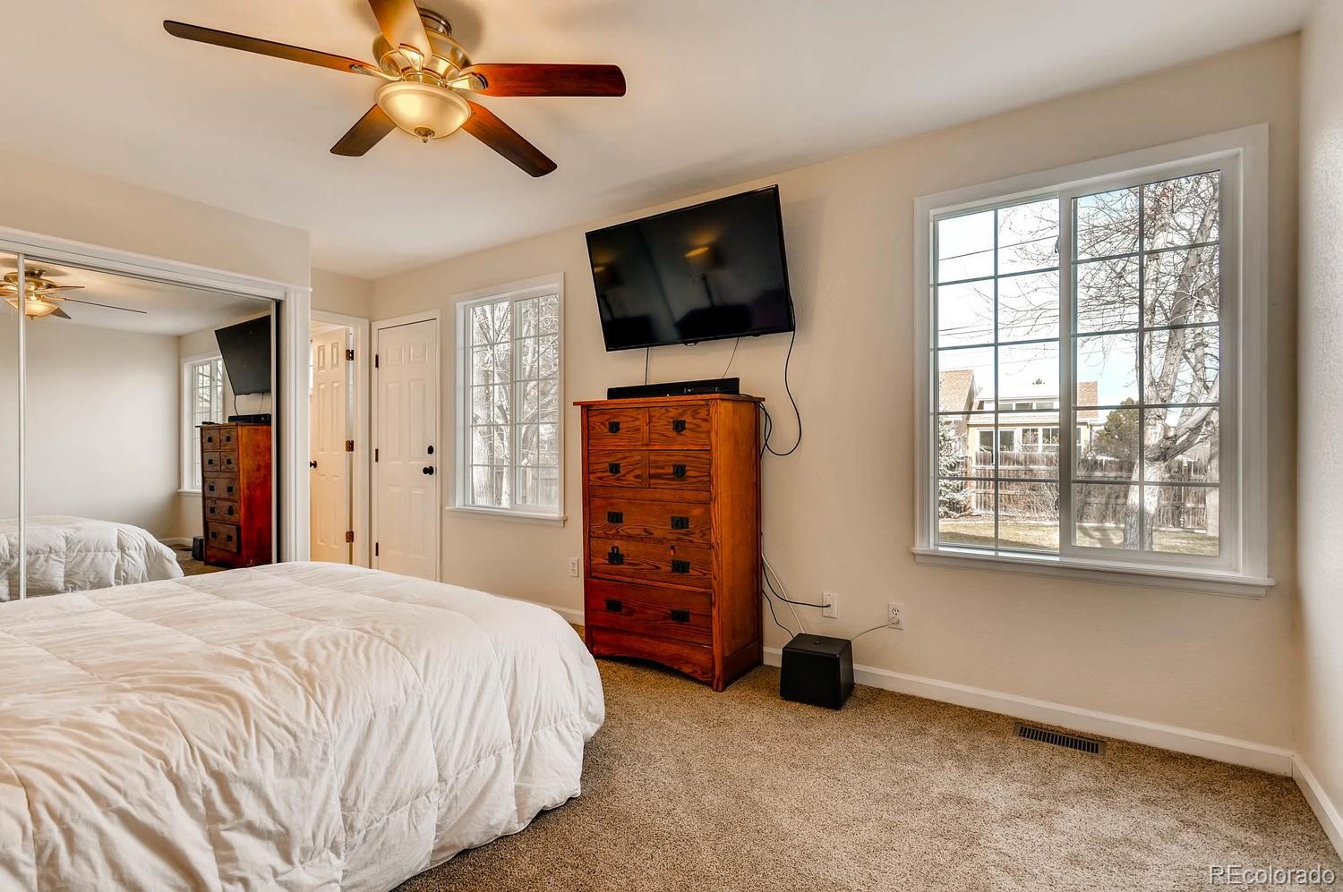 303 West Baseline Road Lafayette, CO 80026 - Photo 11 of 28 a bedroom with a bed and a flat screen tv