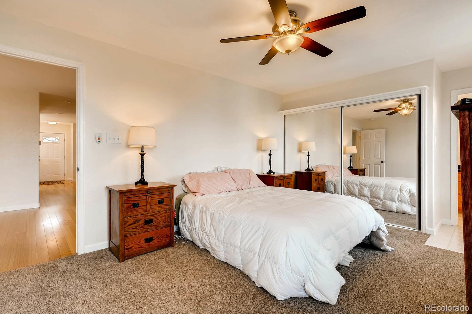 303 West Baseline Road Lafayette, CO 80026 - Photo 12 of 28 a bedroom with a bed and a chandelier
