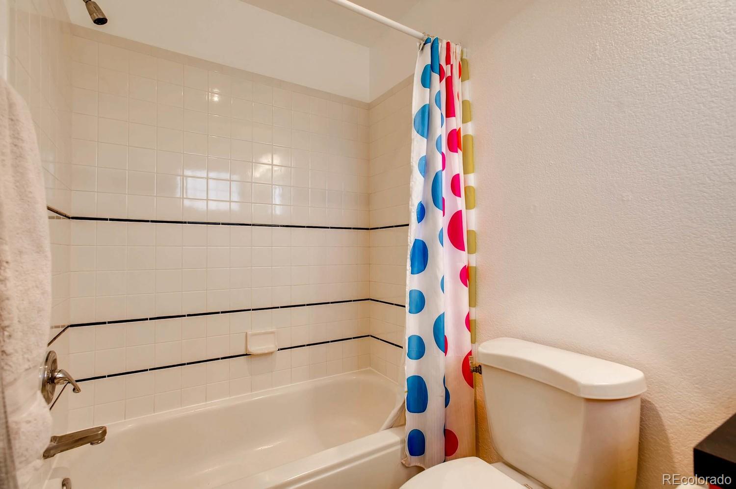 303 West Baseline Road Lafayette, CO 80026 - Photo 14 of 28 a bathroom with a shower and a toilet