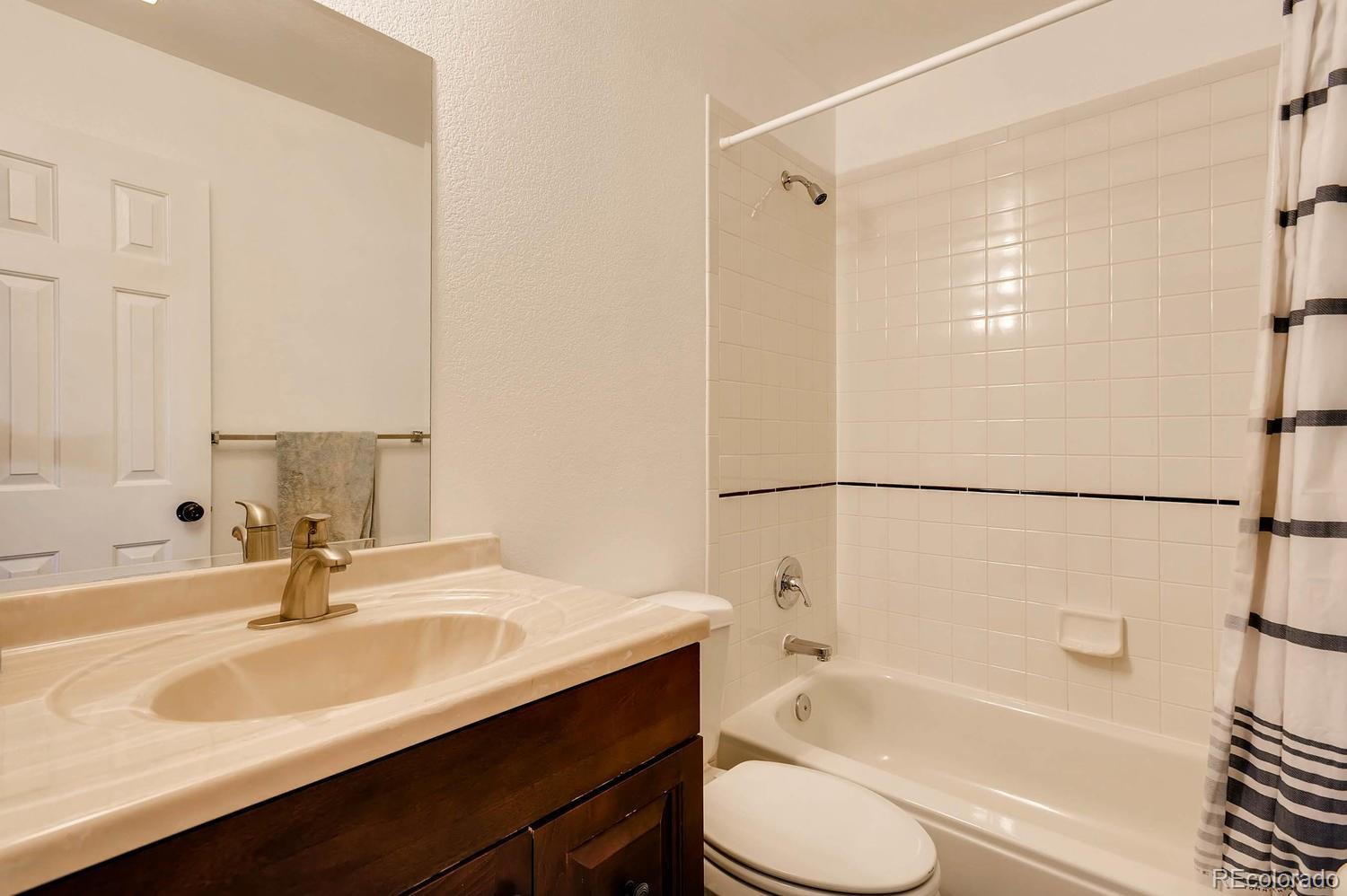 303 West Baseline Road Lafayette, CO 80026 - Photo 17 of 28 a bathroom with a sink toilet and shower