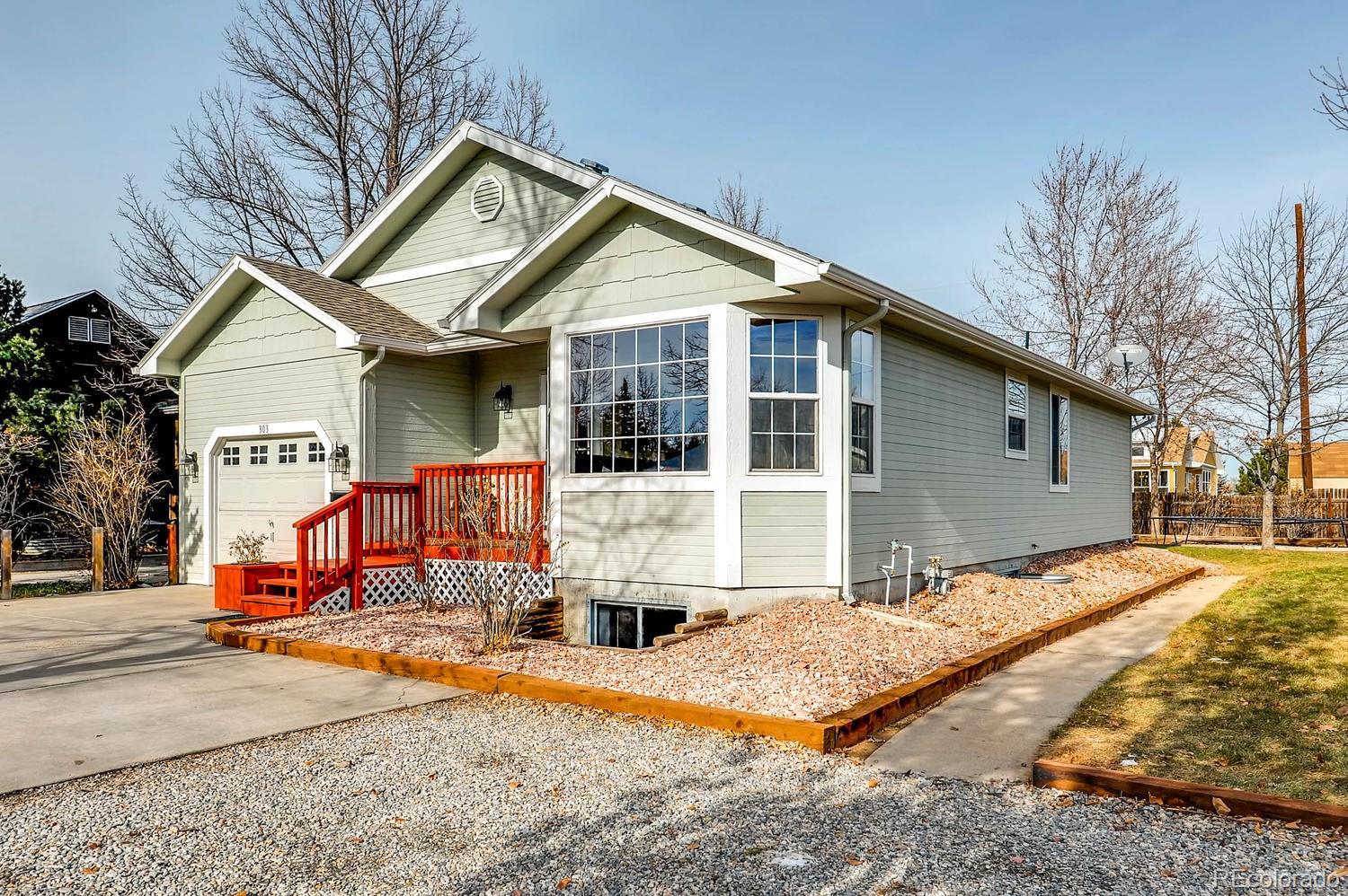 303 West Baseline Road Lafayette, CO 80026 - Photo 2 of 28 a front view of a house with a yard