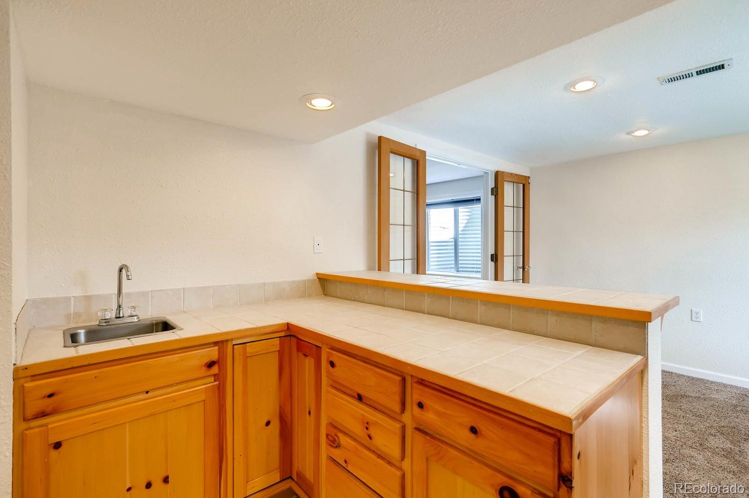 303 West Baseline Road Lafayette, CO 80026 - Photo 21 of 28 a bathroom with a sink and a window