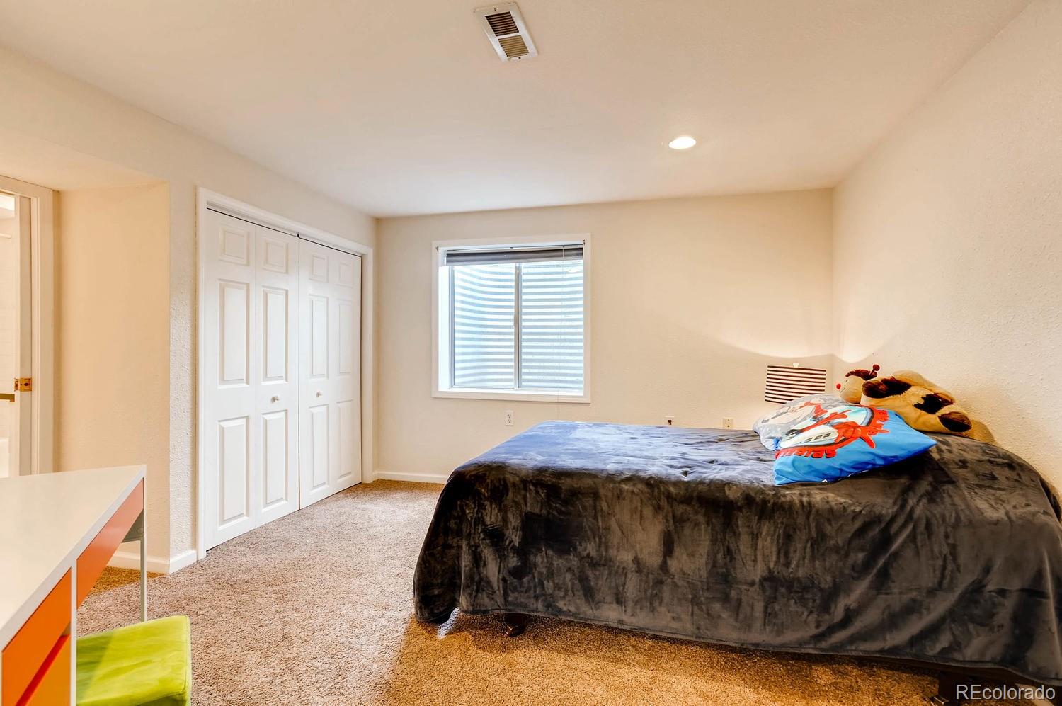 303 West Baseline Road Lafayette, CO 80026 - Photo 22 of 28 a bedroom with a bed and a window