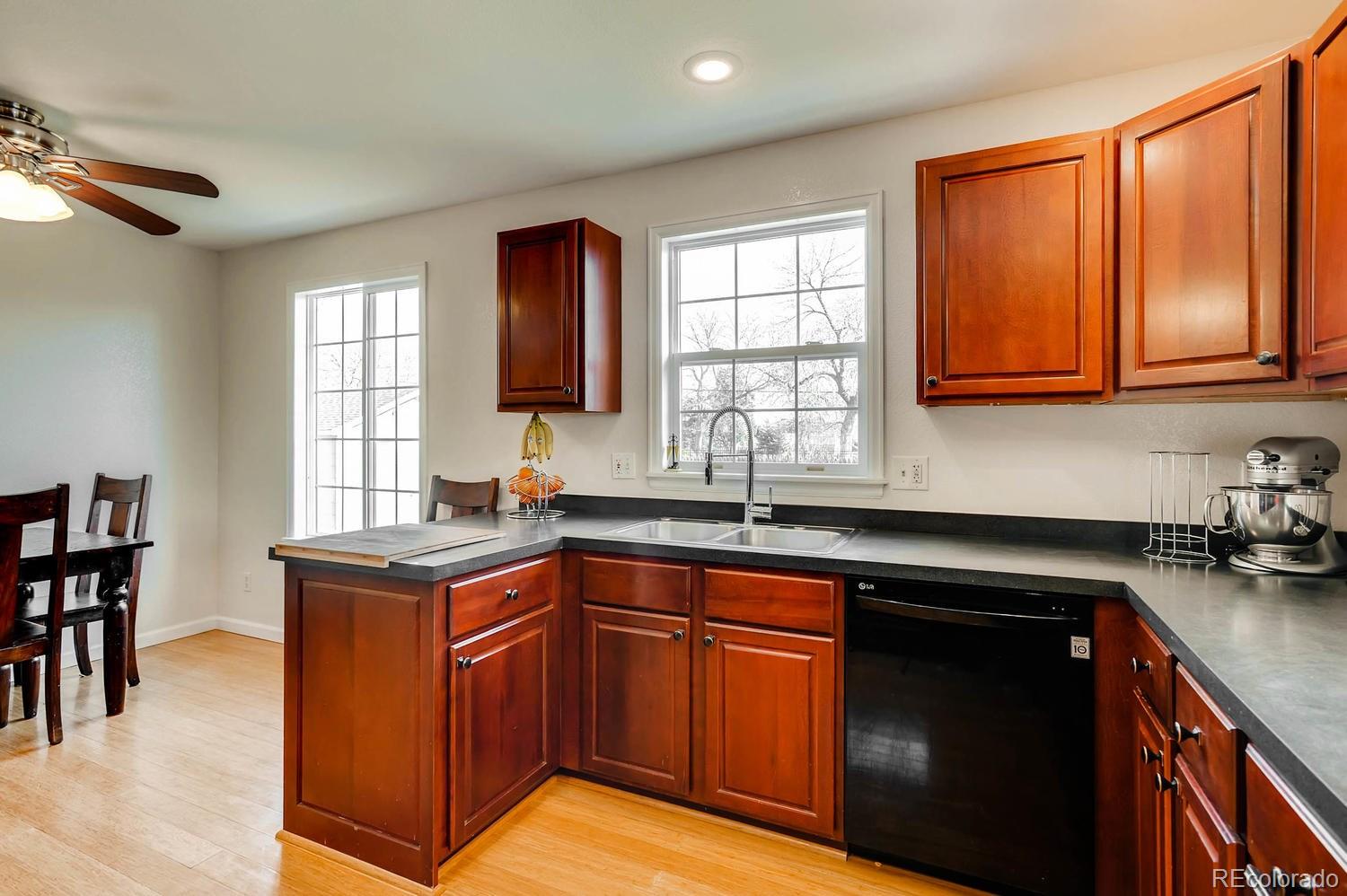 303 West Baseline Road Lafayette, CO 80026 - Photo 8 of 28 a kitchen with stainless steel appliances granite countertop sink stove and cabinets