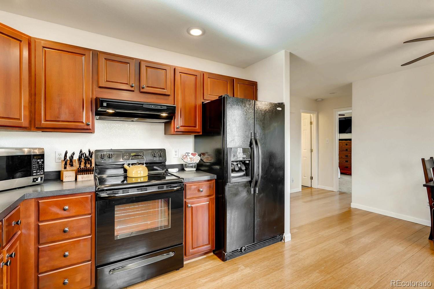 303 West Baseline Road Lafayette, CO 80026 - Photo 10 of 28 a kitchen with stainless steel appliances granite countertop a refrigerator stove and sink