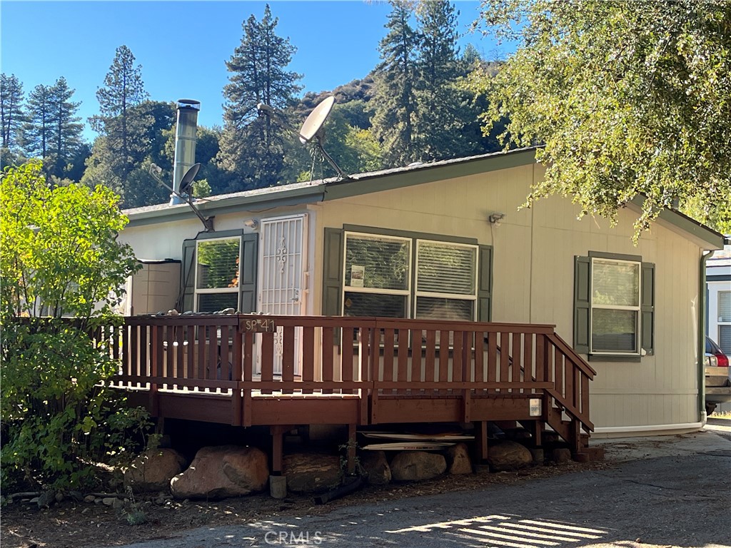 39950 7 Oaks Road, Unit 41 Angelus Oaks, CA 92305 - Photo 1 of 27 a view of a deck with a large window and a table and chairs