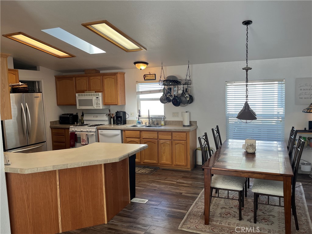 39950 7 Oaks Road, Unit 41 Angelus Oaks, CA 92305 - Photo 11 of 27 a kitchen with a table chairs microwave and cabinets