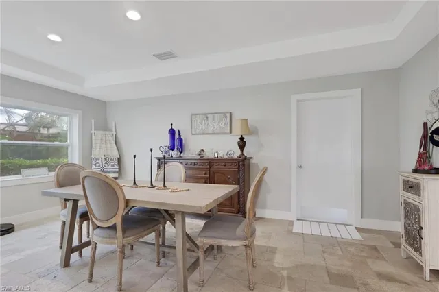 a view of a dining room with furniture and a window