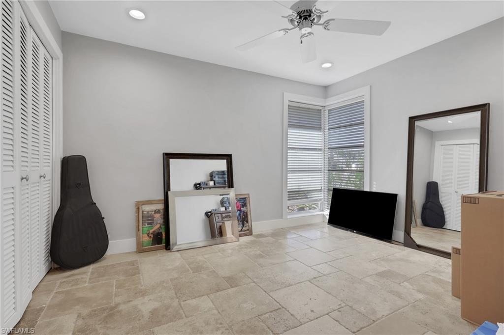 687 Cypress Way East Naples, FL 34110 - Photo 19 of 27 a view of a livingroom with furniture and a ceiling fan