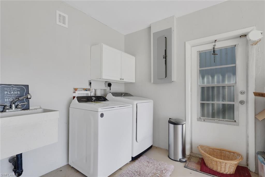 687 Cypress Way East Naples, FL 34110 - Photo 23 of 27 a room with a washing machine and a window