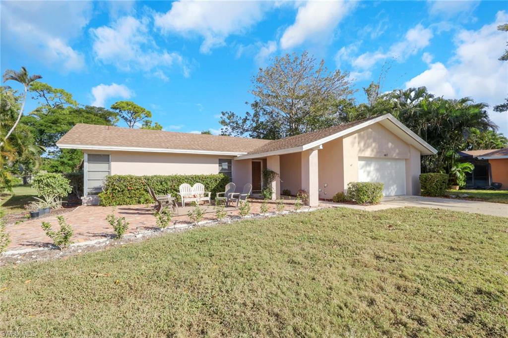 687 Cypress Way East Naples, FL 34110 - Photo 3 of 27 a view of a house with backyard and sitting area