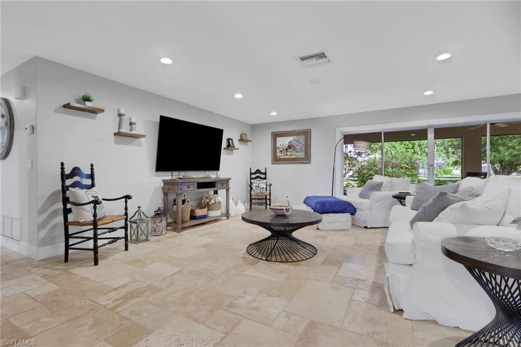 687 Cypress Way East Naples, FL 34110 - Photo 6 of 27 a living room with furniture and a flat screen tv