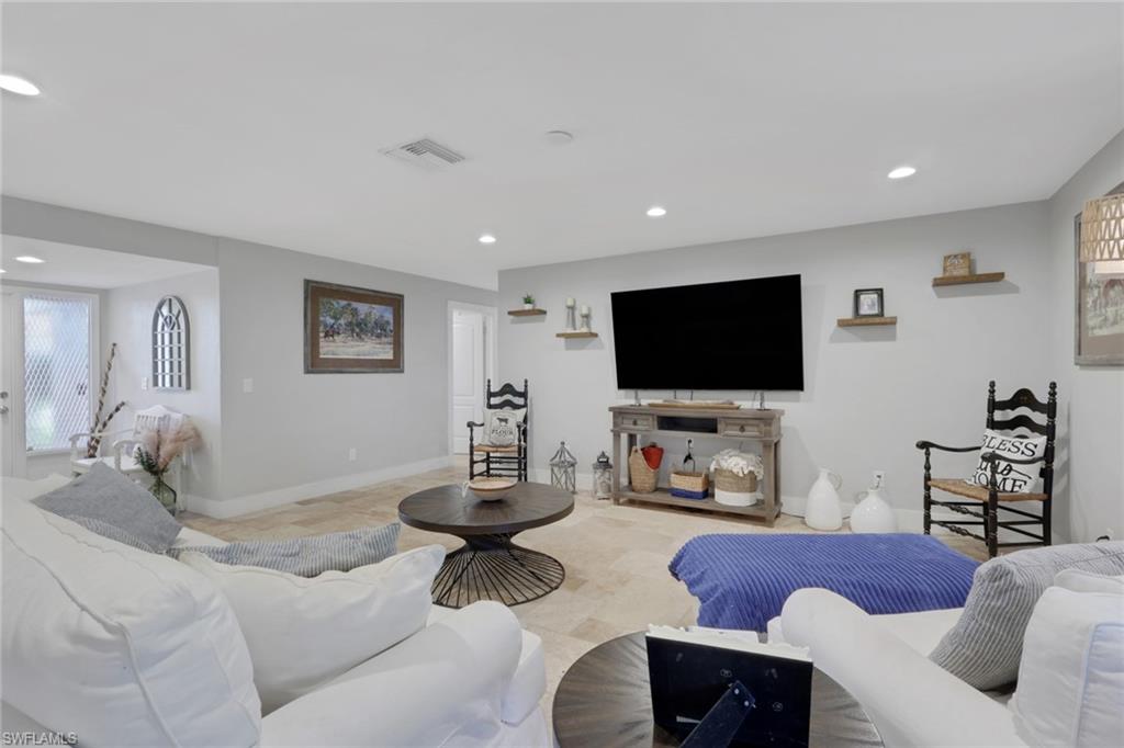 687 Cypress Way East Naples, FL 34110 - Photo 9 of 27 a living room with furniture and a flat screen tv