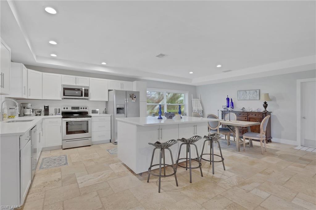 687 Cypress Way East Naples, FL 34110 - Photo 10 of 27 a kitchen with a table and chairs in it
