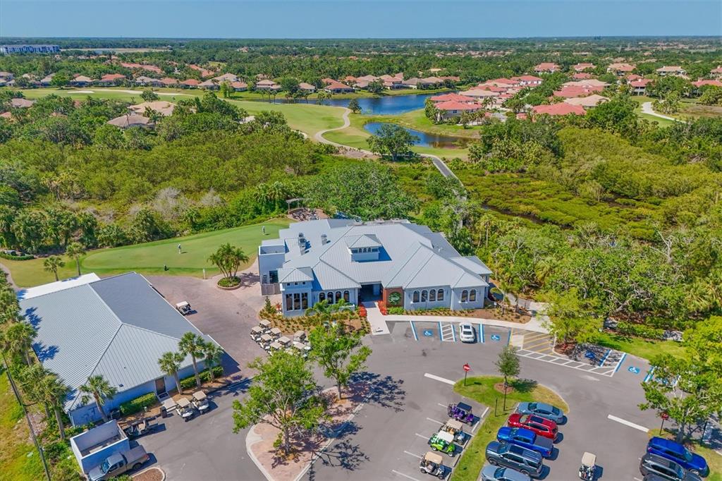 10622 Conch Shell Terrace Bradenton, FL 34212 - Photo 65 of 69 an aerial view of a house with a garden and lake view