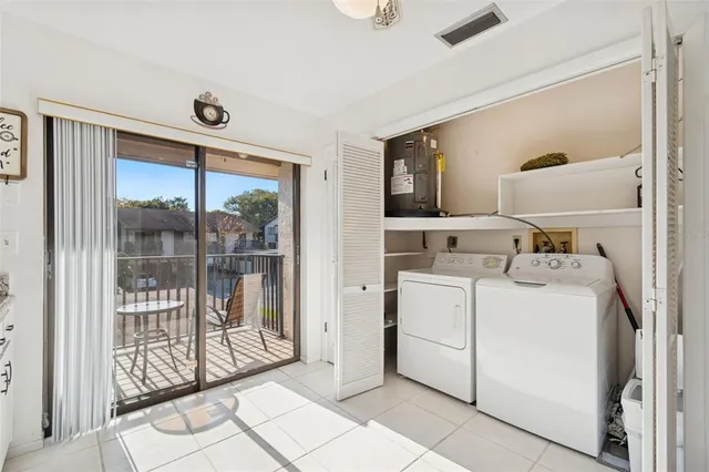 a view of washer and dryer with bathroom in the background