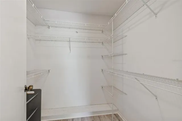 a view of walk in closet with empty racks
