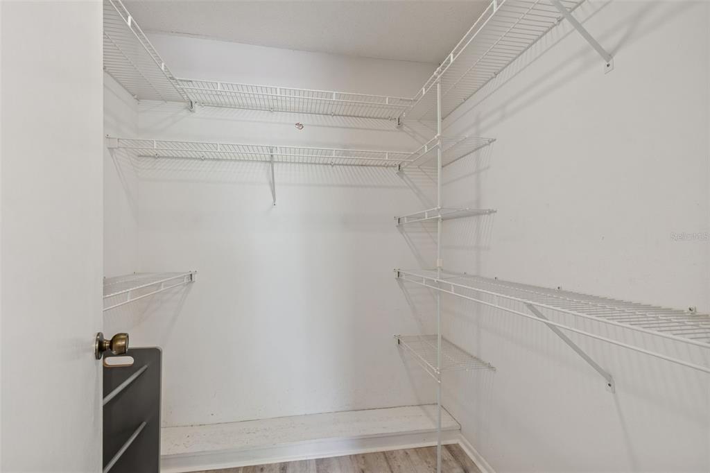 12906 Wedgewood Way, Unit D Hudson, FL 34667 - Photo 23 of 54 a view of walk in closet with empty racks