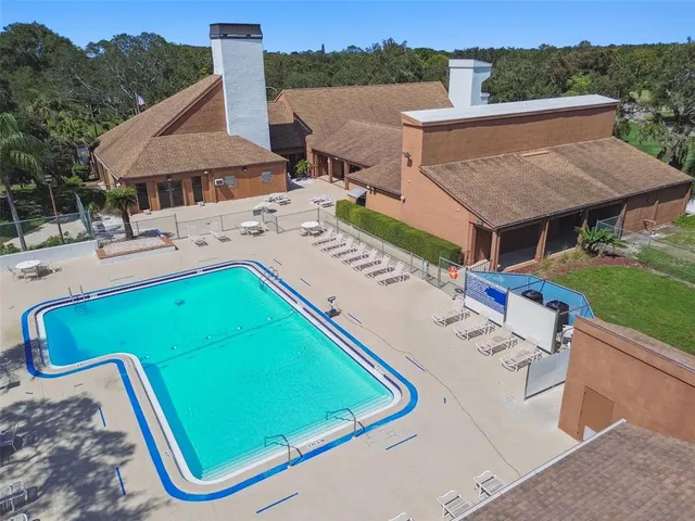 an aerial view of a multi story residential apartment building with a yard