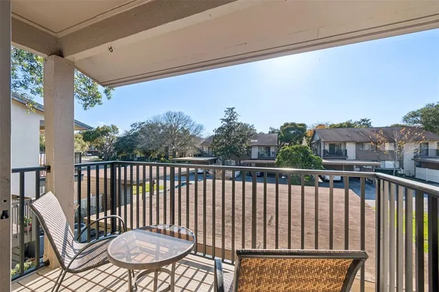 a view of a balcony with chairs